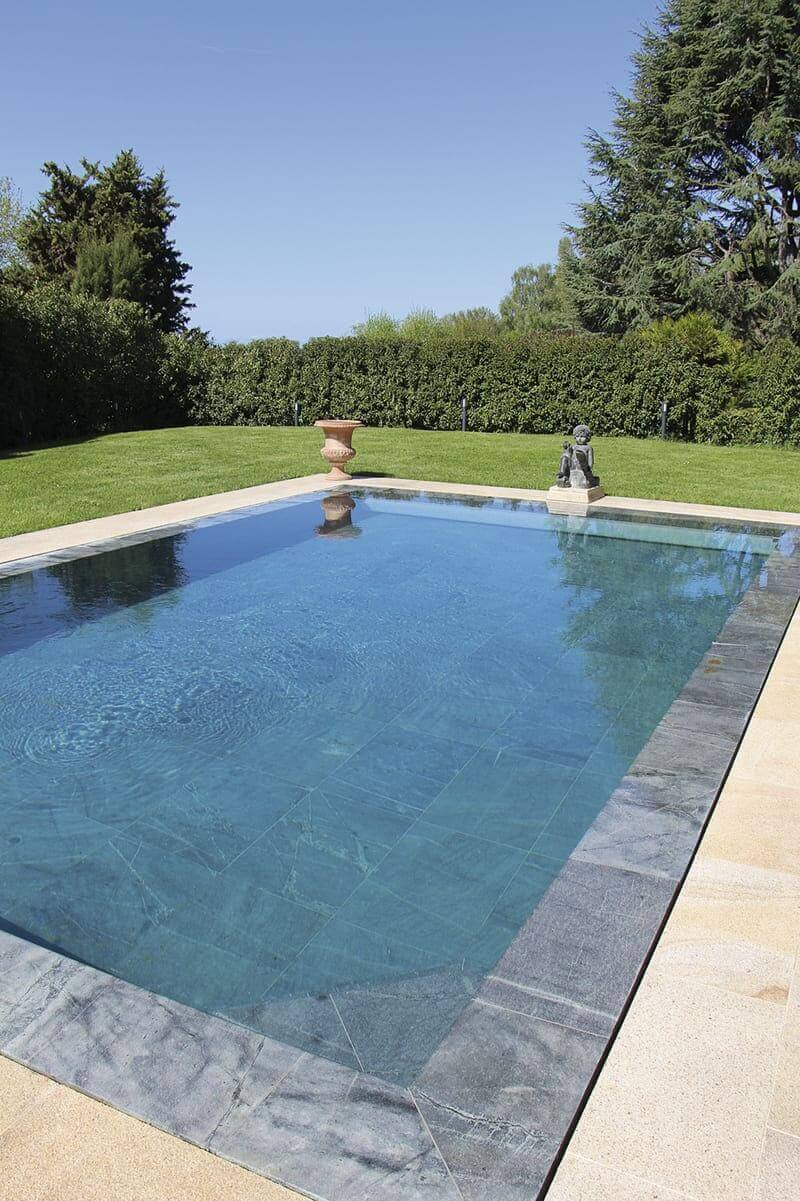 Piscine pierre naturelle jaune et grise jardin extérieur